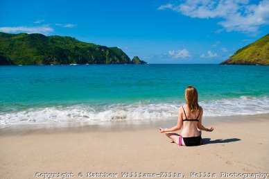 Woman Meditating at Mawun Beach, a Tropical Paradise in South Lombok, Indonesia